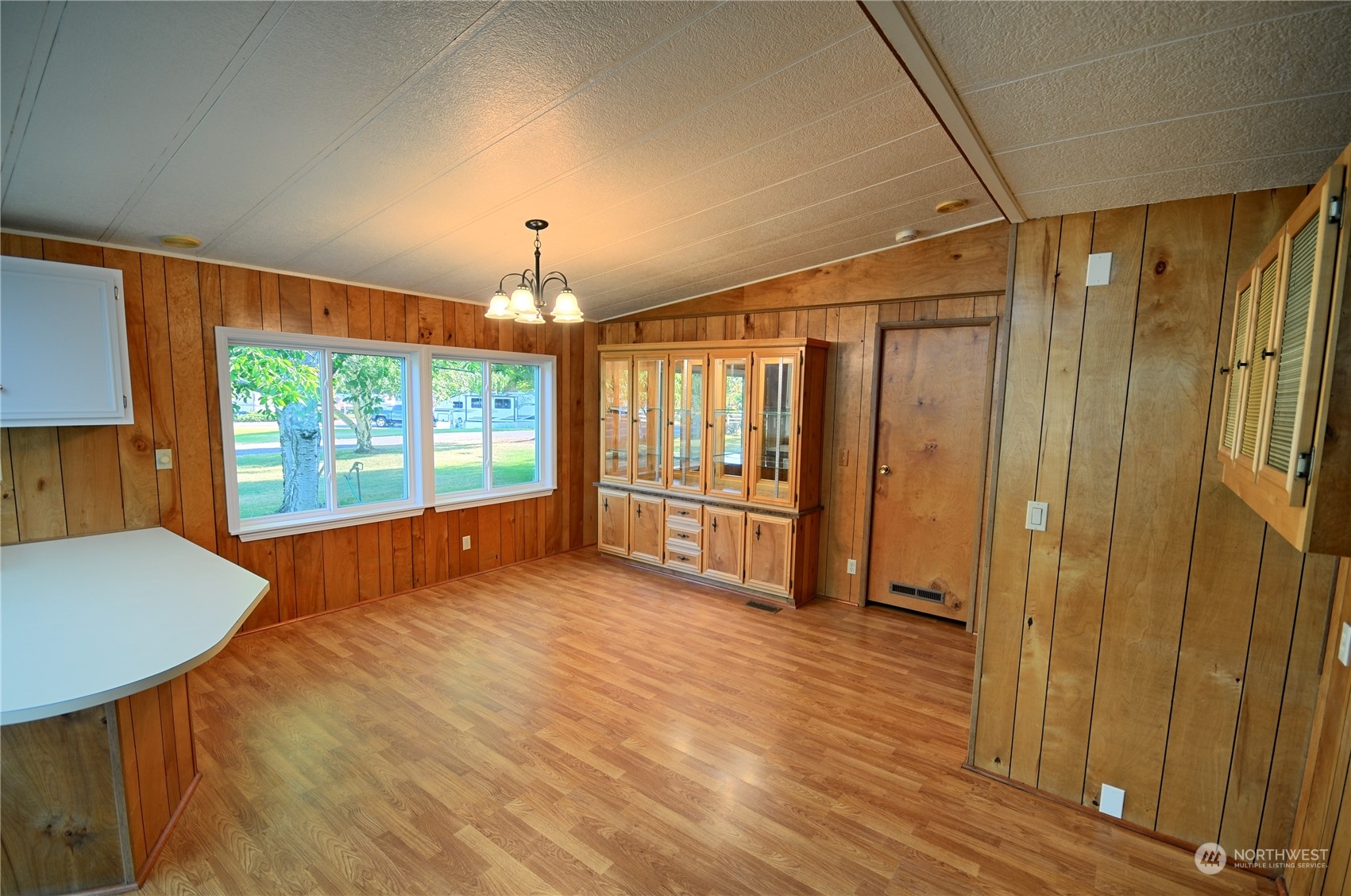 7472 Rd F Southeast, Unit 8 Othello, WA 99344 - Photo 10 of 23 a view of an empty room with glass door and wooden floor