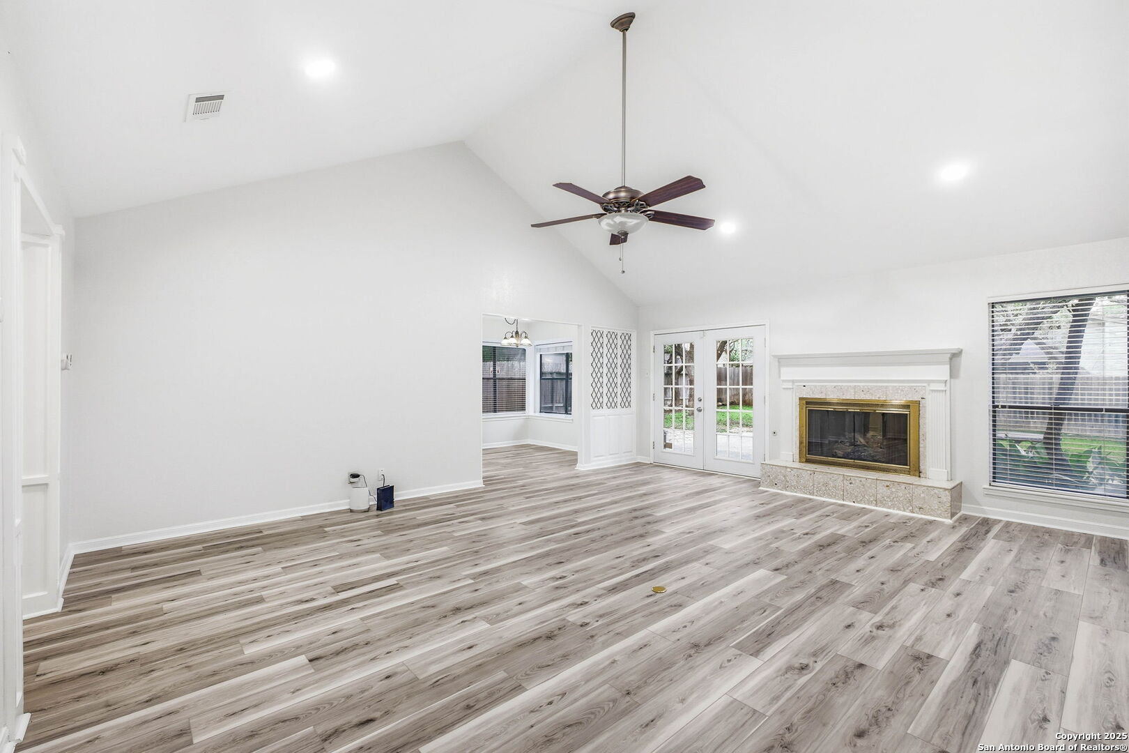 13123 Hunters Spring San Antonio, TX 78230 - Photo 16 of 42 a view of a livingroom with a fireplace a ceiling fan and wooden floor