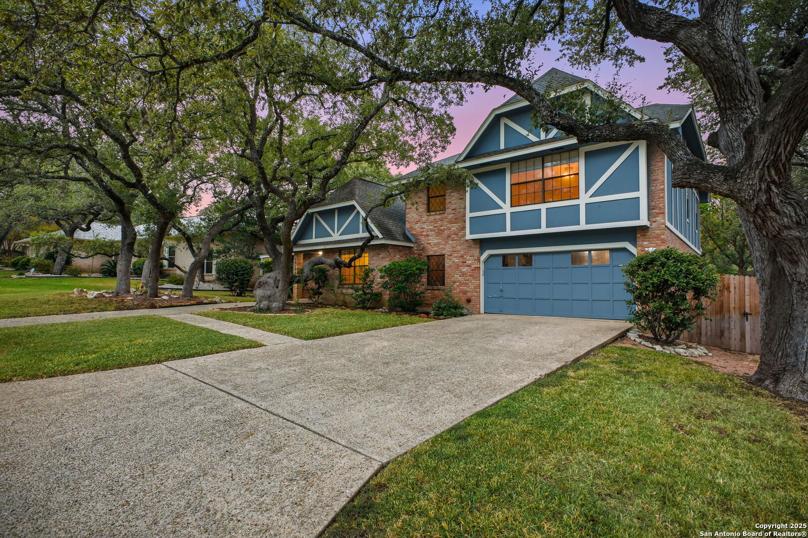 13123 Hunters Spring San Antonio, TX 78230 - Photo 3 of 42 a front view of a house with a yard and garage