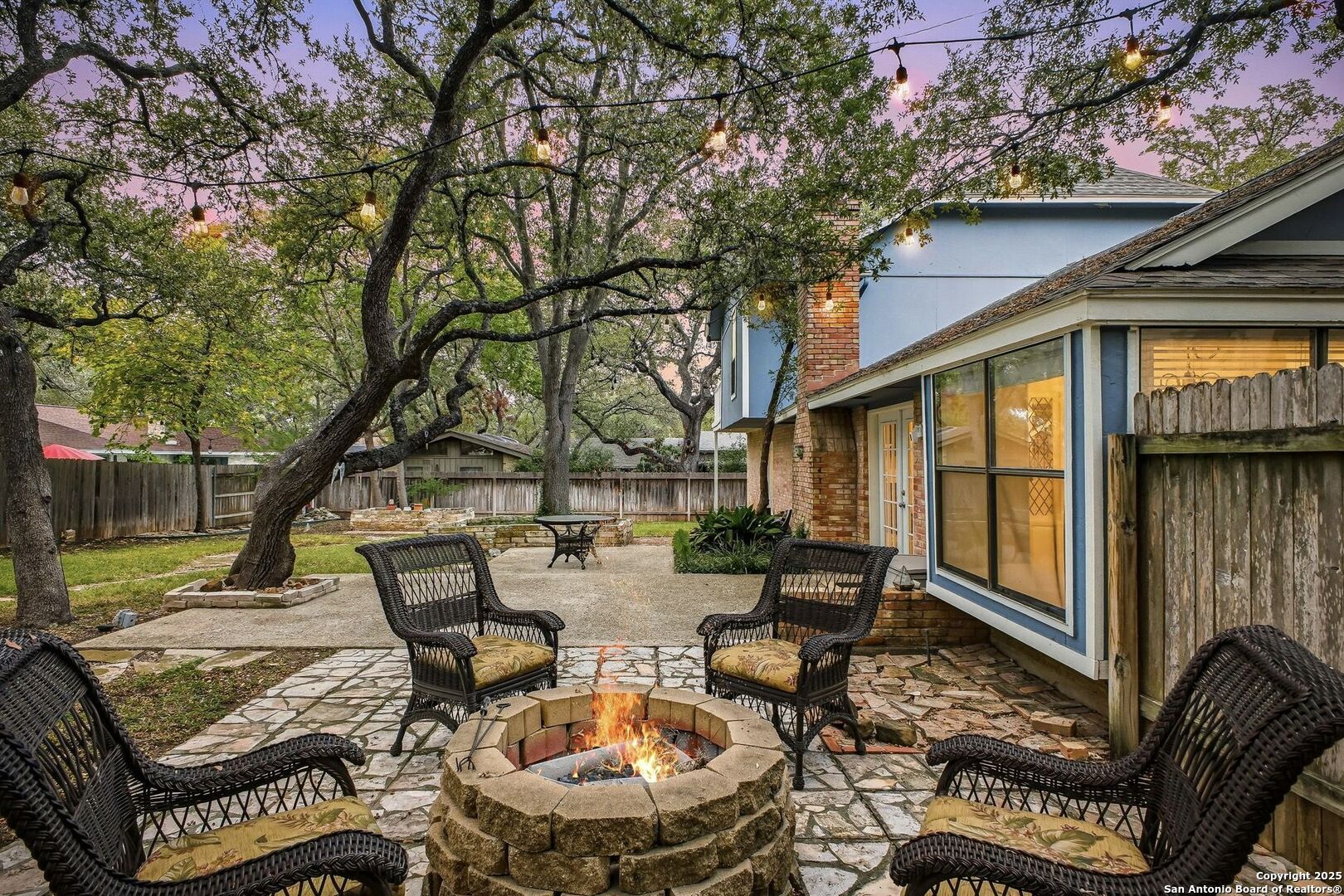 13123 Hunters Spring San Antonio, TX 78230 - Photo 38 of 42 a view of a patio with table and chairs and potted plants with large tree