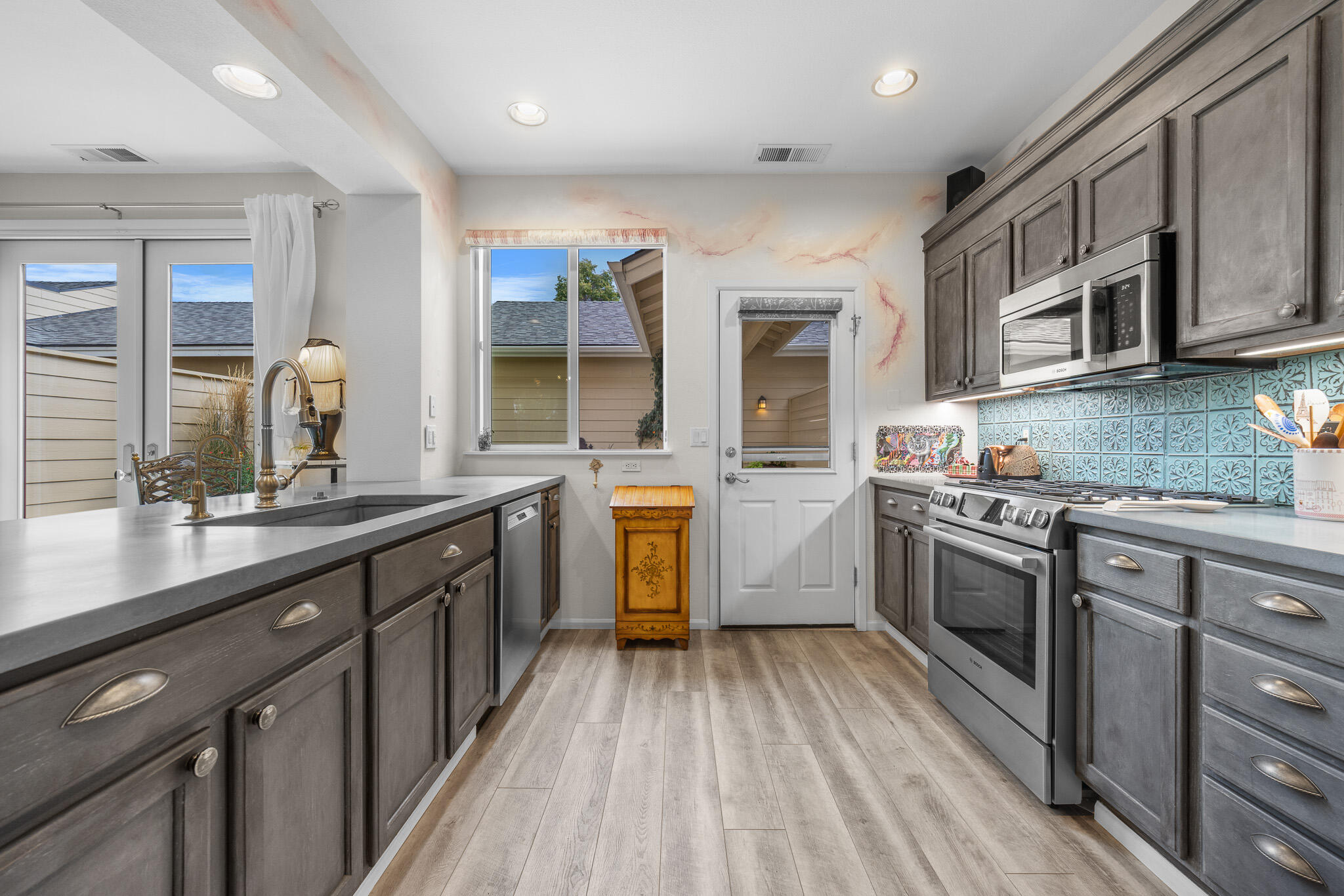 624 Southwest Hill Street Bend, OR 97702 - Photo 10 of 45 a kitchen with stainless steel appliances granite countertop lots of counter space and a sink