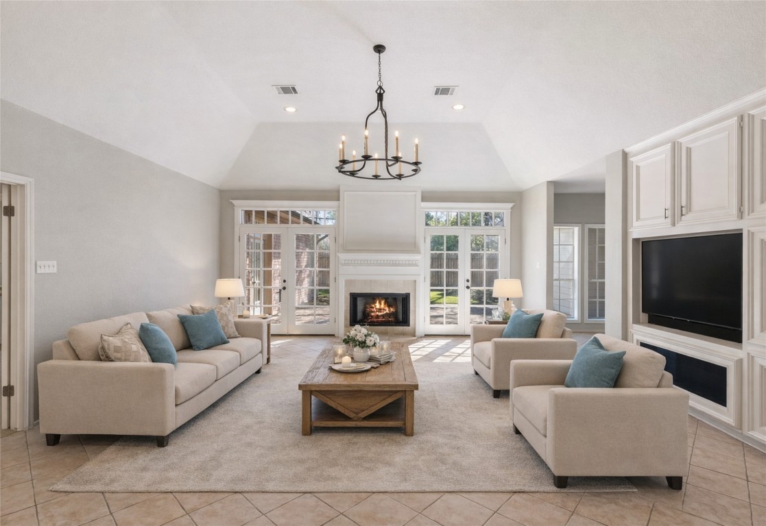 25722 Overlake Drive Spring, TX 77380 - Photo 11 of 50 This spacious living room features high vaulted ceilings, a cozy fireplace, and abundant natural light from the large windows and double set of French doors.