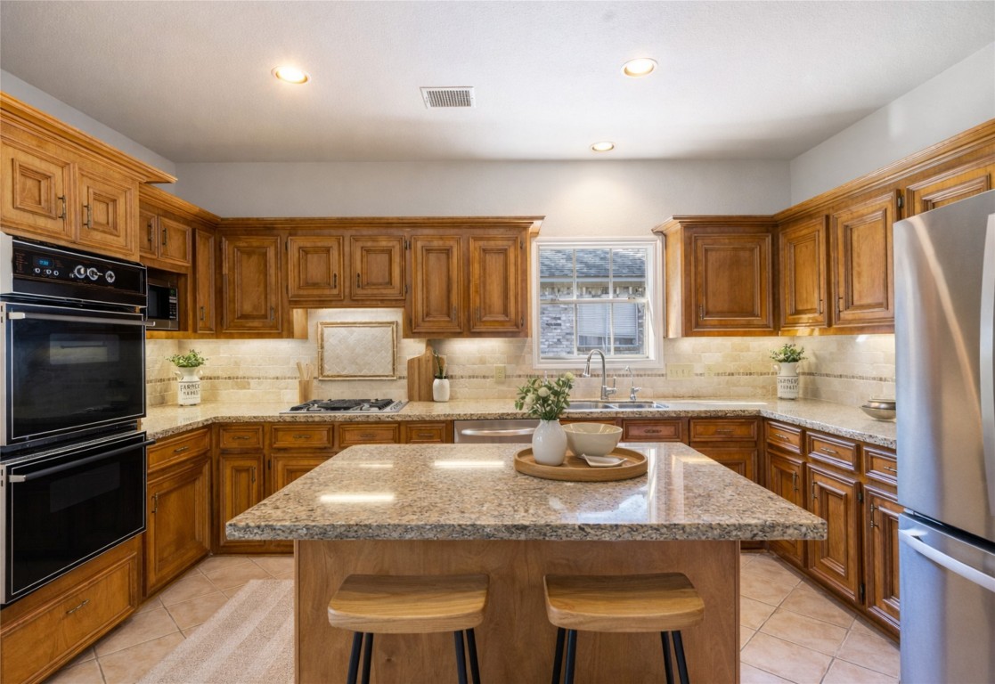 25722 Overlake Drive Spring, TX 77380 - Photo 17 of 50 The island breakfast bar is perfect for quick meals! The kitchen is also equipped with a reverse osmosis system that was just serviced last month and a newer garbage disposal!