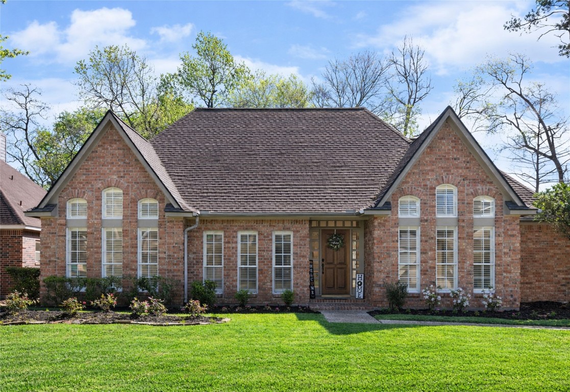 25722 Overlake Drive Spring, TX 77380 - Photo 2 of 50 Notice the low maintenance brick exterior, symmetrical design, welcoming front porch, and large arched windows. This home offers a classic and inviting curb appeal, a well-maintained lawn, and an underground sprinkler system.