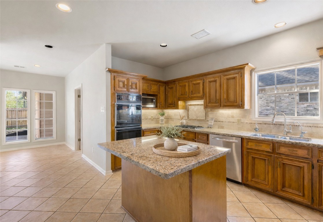 25722 Overlake Drive Spring, TX 77380 - Photo 21 of 50 Take note of the charming window above the sink and the built-in downdraft range to the left.