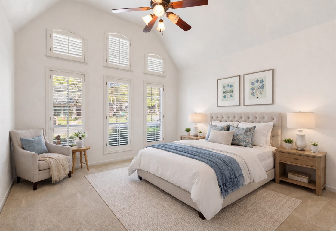 25722 Overlake Drive Spring, TX 77380 - Photo 32 of 50 Positioned at the front right wing of the home off the primary retreat hallway, this secondary bedroom showcases soaring ceilings, plentiful windows with plantation shutters, and a spacious closet on the right.
