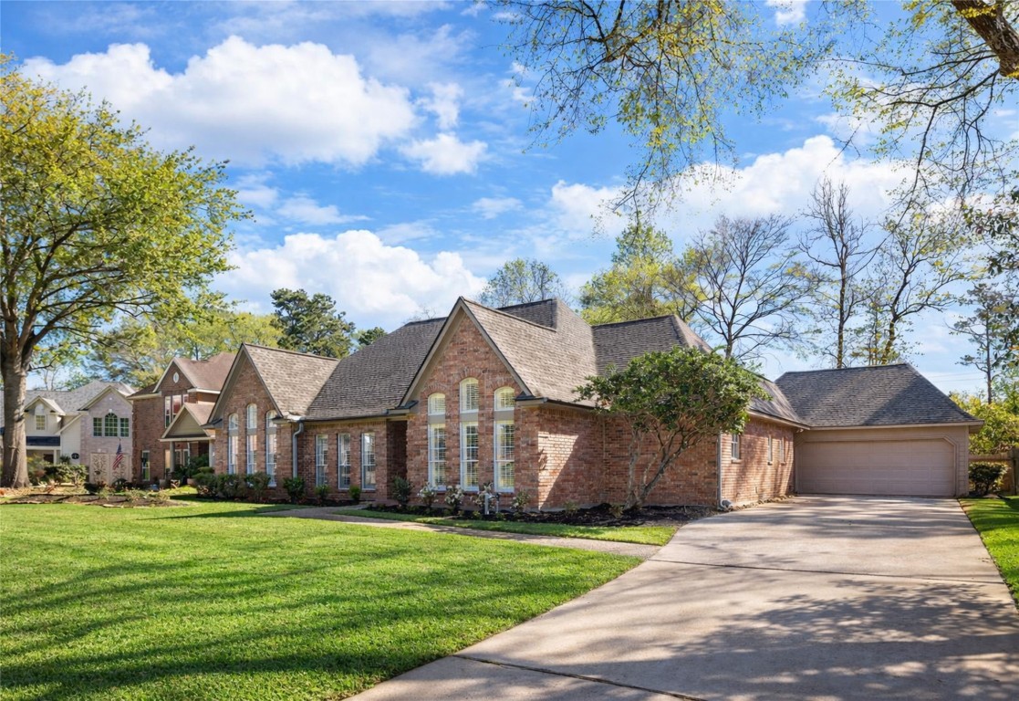 25722 Overlake Drive Spring, TX 77380 - Photo 4 of 50 The extended driveway leads to an oversized two-car garage, providing plenty of parking space for family and guests!