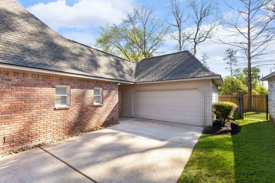 25722 Overlake Drive Spring, TX 77380 - Photo 44 of 50 A detached oversized two-car garage also includes a water softener that was serviced last month and the water heater, offering the advantage of ground-level placement rather than attic installation.