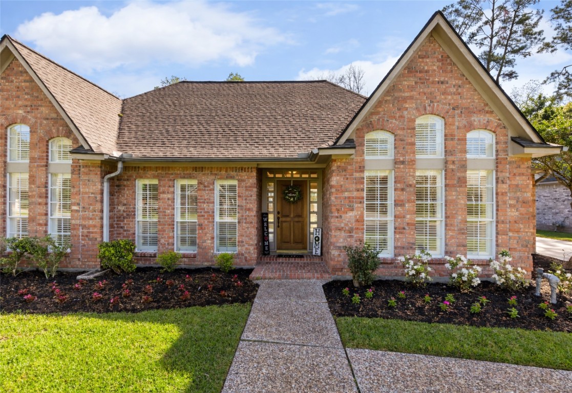 25722 Overlake Drive Spring, TX 77380 - Photo 5 of 50 The windows and plantation shutters add elegance, and the triangular roof design provides character. Perfect for a welcoming atmosphere!