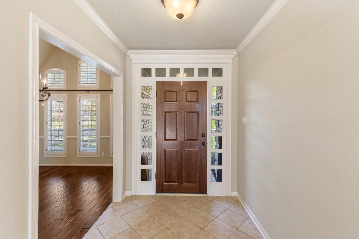 25722 Overlake Drive Spring, TX 77380 - Photo 7 of 50 This photo showcases the welcoming entry, solid wood front door featuring glass side panels, and transom windows.