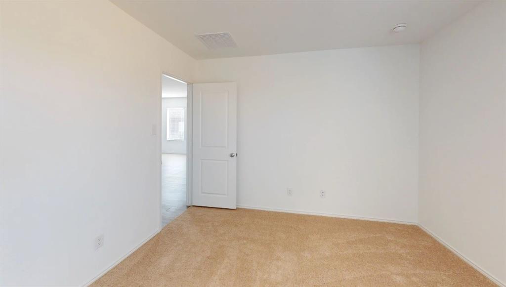 9757 Platteview Road Fort Worth, TX 76179 - Photo 6 of 19 Neutral-toned carpet flooring with white baseboards and walls