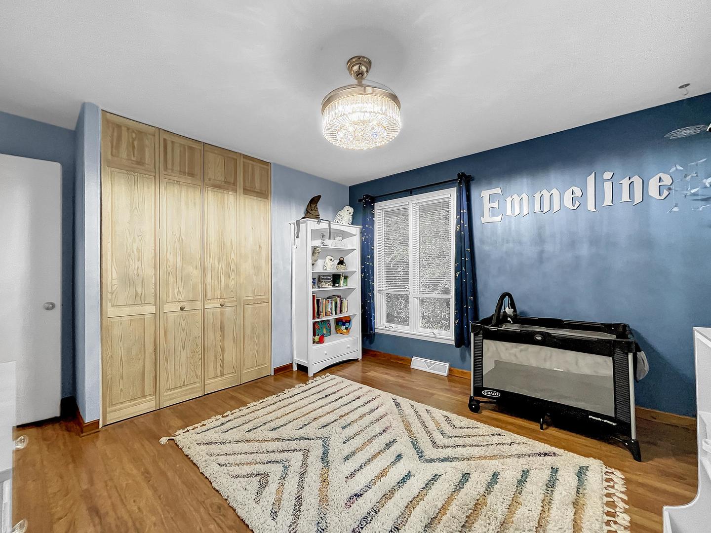 25 Aldon Road Montgomery, IL 60538 - Photo 21 of 38 a bedroom with a bed and a chandelier