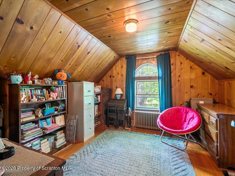 71 Pleasant Avenue Thompson, PA 18465 - Photo 19 of 37 a room with lots of books and a large window