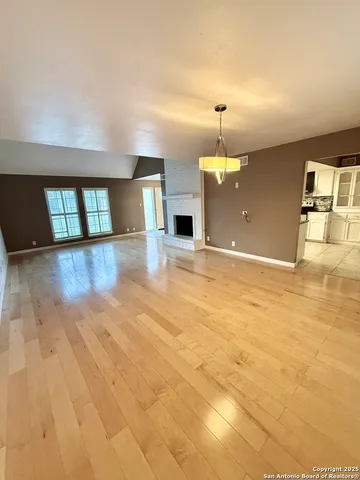 a view of a kitchen with a sink and an empty room