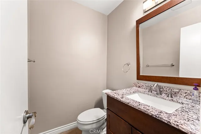 a kitchen with wooden floors and stainless steel appliances
