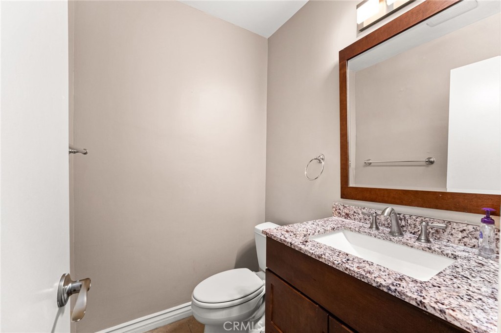 3751 Prestwick Drive Los Angeles, CA 90027 - Photo 11 of 50 a bathroom with a granite countertop sink toilet and mirror