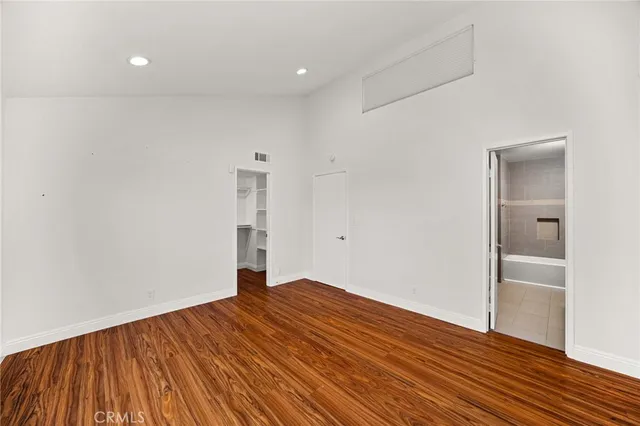 a bathroom with a granite countertop sink mirror and a bathtub