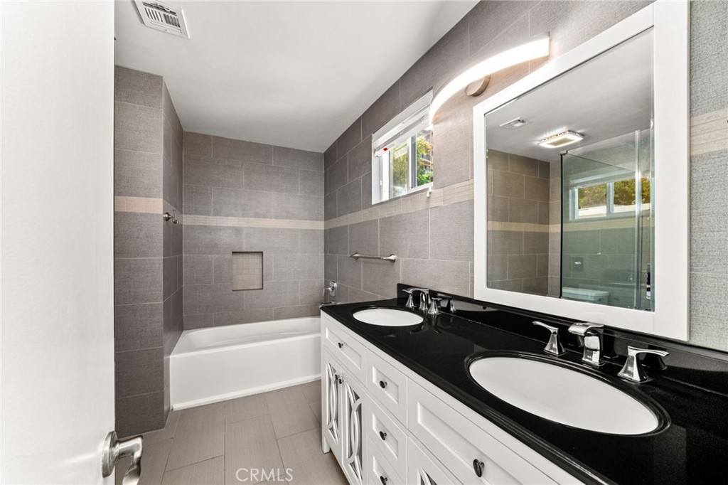 3751 Prestwick Drive Los Angeles, CA 90027 - Photo 28 of 50 a bathroom with a granite countertop sink mirror and a bathtub