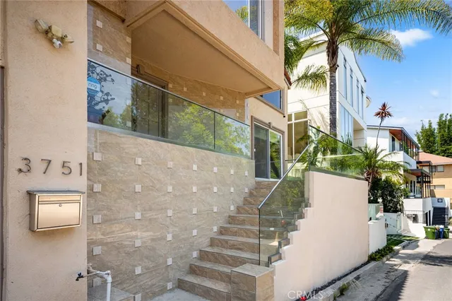 a view of a balcony with a potted plants and palm trees