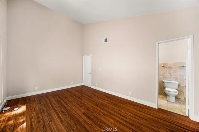a bathroom with a toilet sink double vanity and mirror