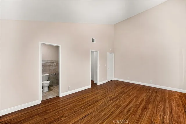 a bathroom with a granite countertop toilet sink and mirror