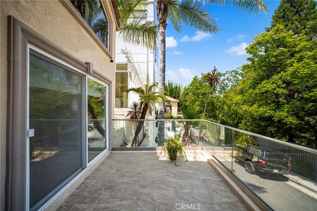 3751 Prestwick Drive Los Angeles, CA 90027 - Photo 4 of 50 a view of a balcony with a potted plants and palm trees