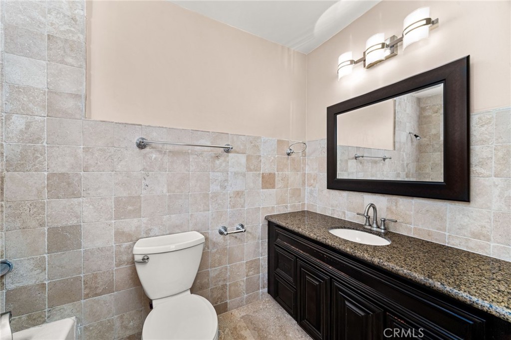 3751 Prestwick Drive Los Angeles, CA 90027 - Photo 41 of 50 a bathroom with a granite countertop toilet sink and mirror