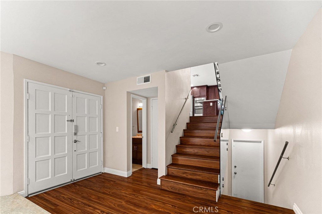 3751 Prestwick Drive Los Angeles, CA 90027 - Photo 10 of 50 a view of a hallway with stairs and wooden floor