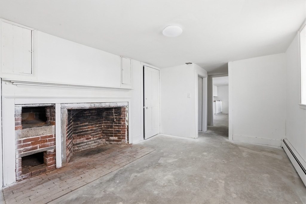 4 Townsend Street Pepperell, MA 01463 - Photo 12 of 27 a view of an empty room with a fireplace