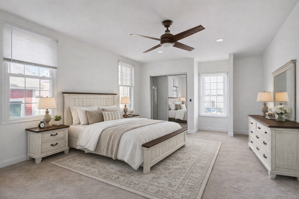 4 Townsend Street Pepperell, MA 01463 - Photo 18 of 27 a bedroom with a large bed and a chandelier fan