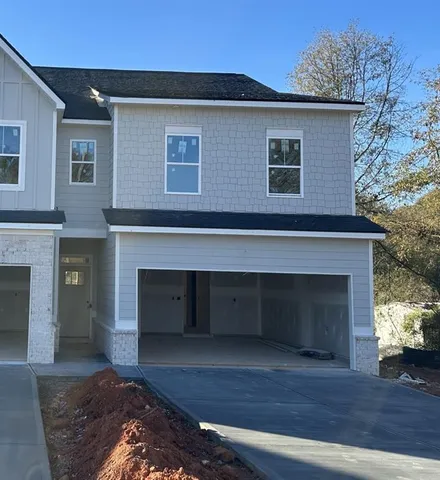 a front view of a house with a garage