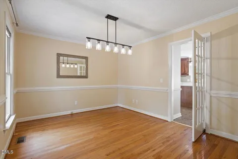 a view of a room with wooden floor and window