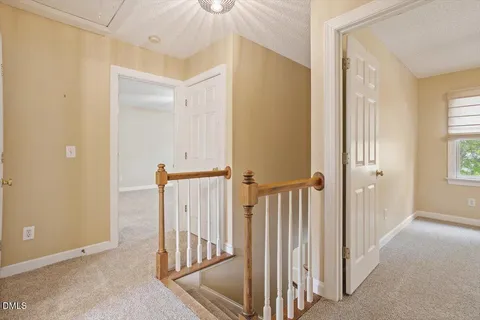 a view of a hallway with entryway door
