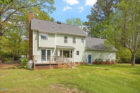 a front view of a house with swimming pool and porch