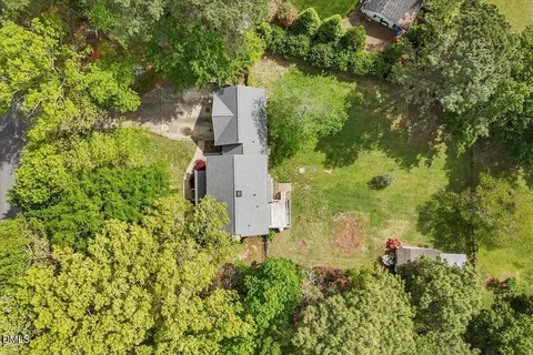 an aerial view of a house with a yard and garden