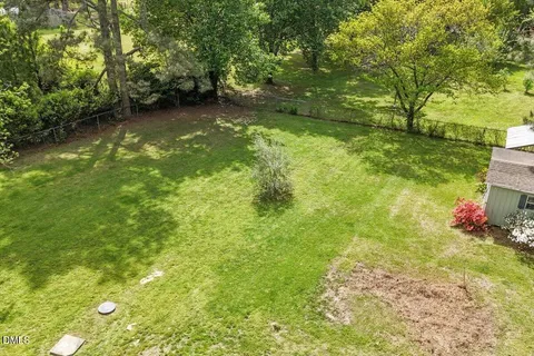 a view of a yard with a house in the background