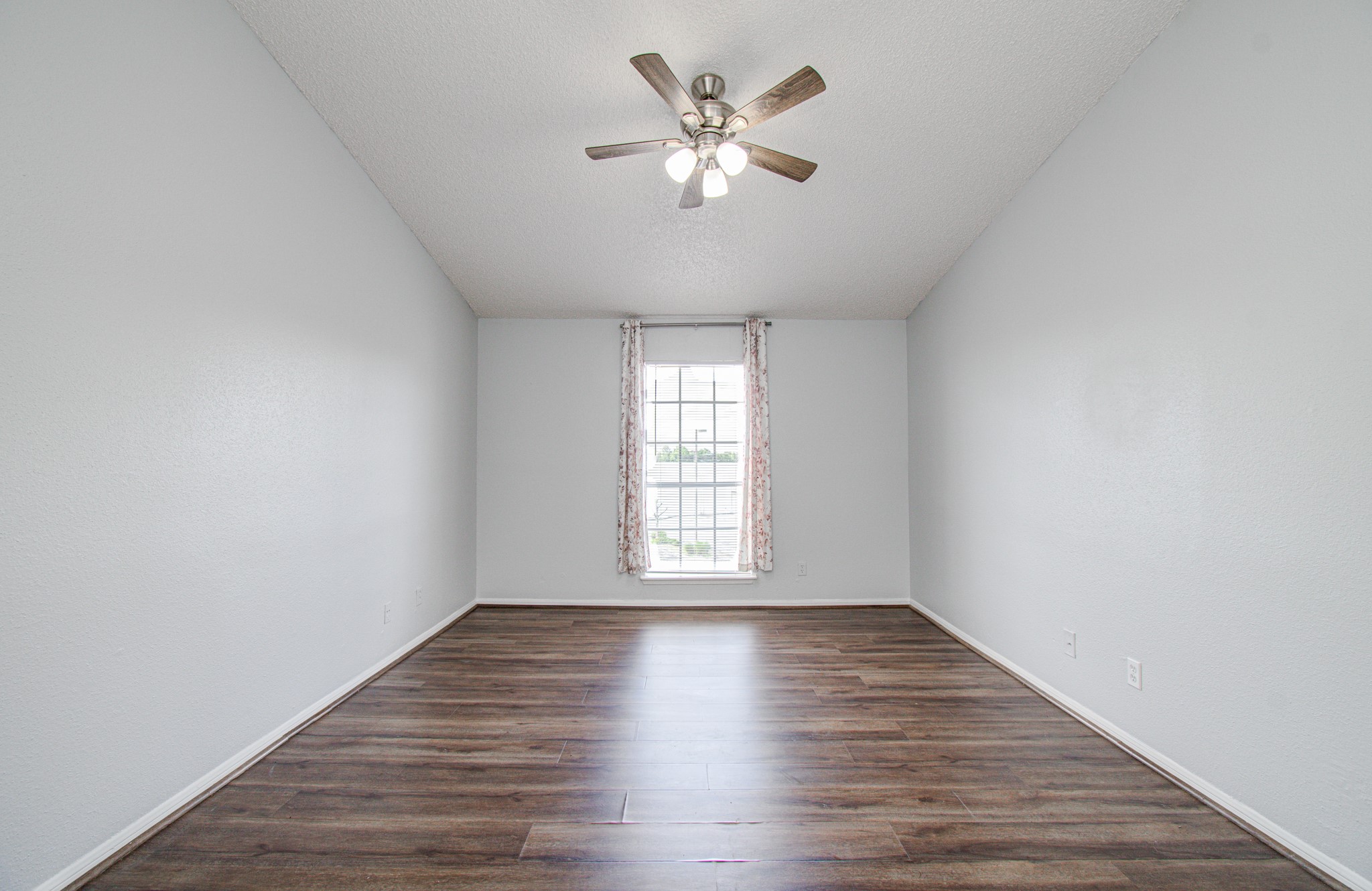 10101 South Gessner Road, Unit 405 Houston, TX 77071 - Photo 18 of 27 a view of an empty room with wooden floor and a window