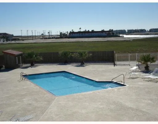 a swimming pool with outdoor seating and yard