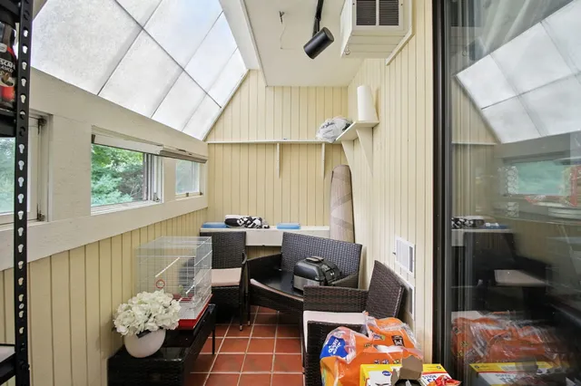 a living room with furniture and flowers