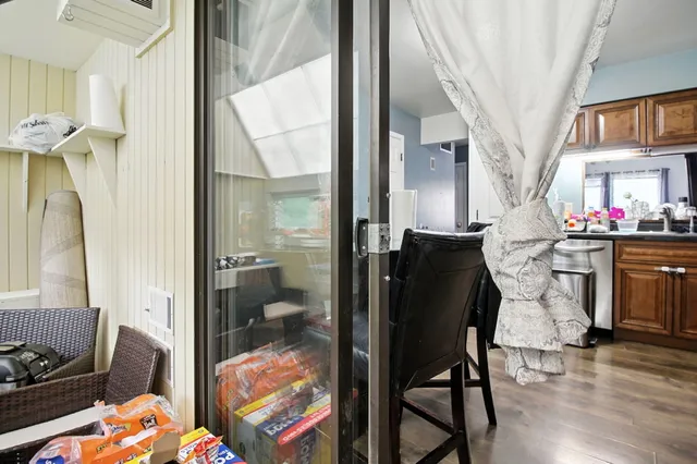a dining room with furniture and a floor to ceiling window