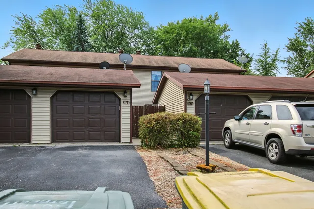 a front view of a house with parking space
