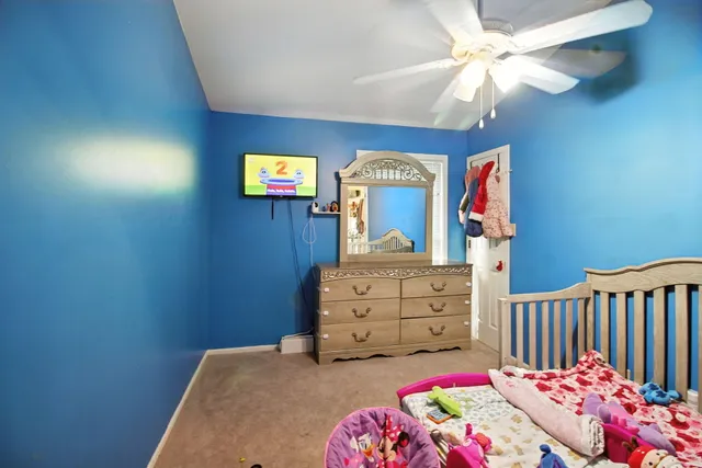 a bedroom with a bed and a dresser