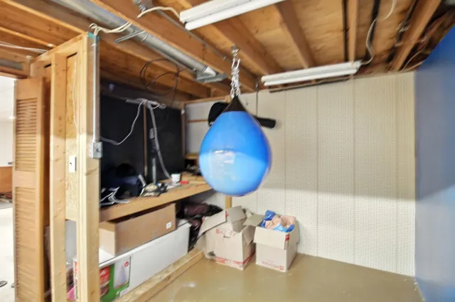 a view of storage and utility room with two washing machine