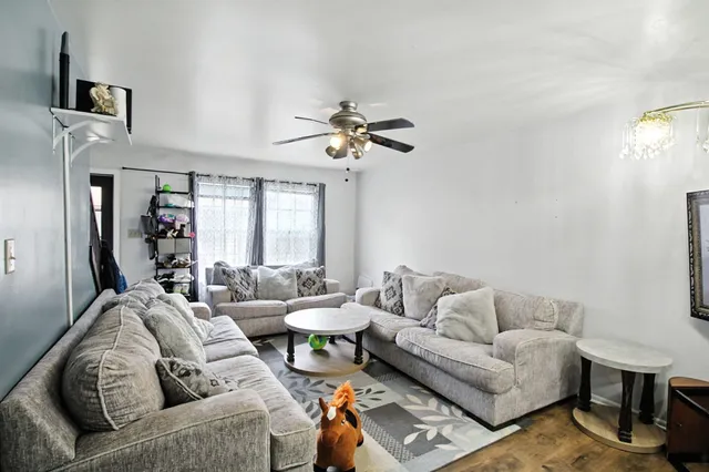 a living room with furniture a chandelier and a window
