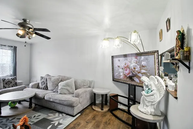 a living room with furniture a rug and a chandelier