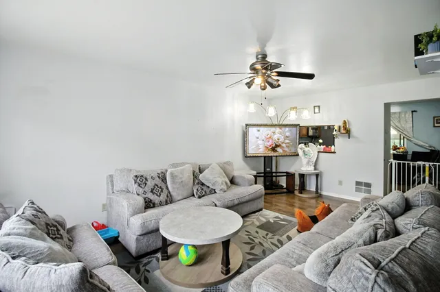 a living room with furniture and a chandelier
