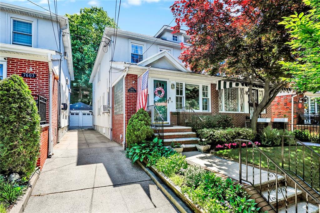 7607 Colonial Road Brooklyn, NY 11209 - Photo 31 of 35 a front view of a house with a yard and potted plants