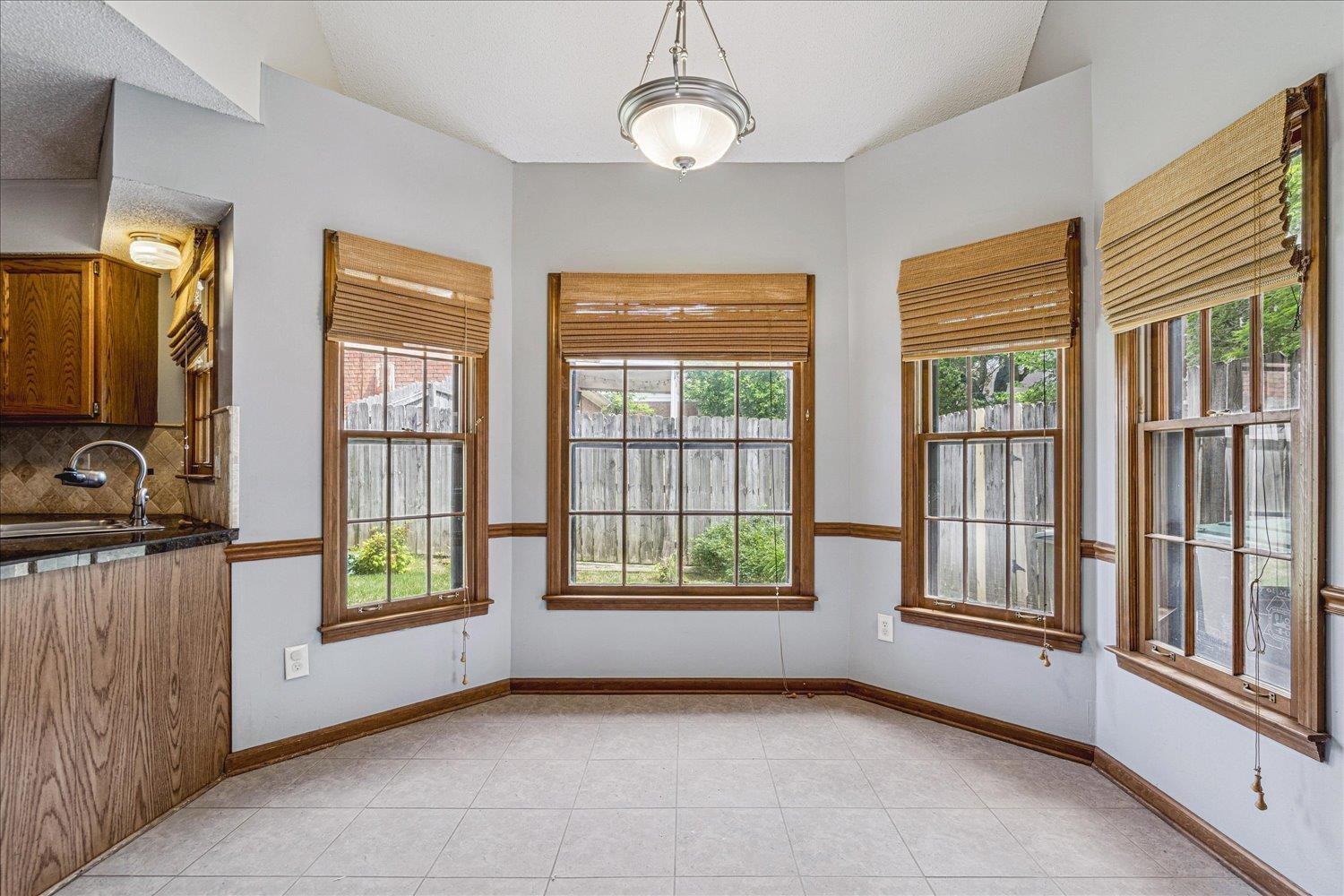 8529 Buckhurst Road Memphis, TN 38016 - Photo 16 of 36 Unfurnished dining area featuring a sink and light tile patterned floors