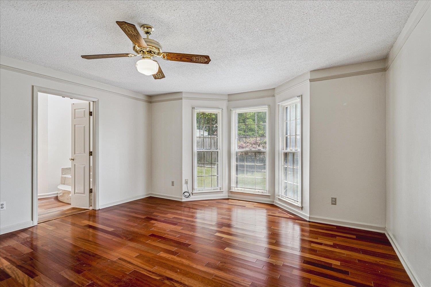 8529 Buckhurst Road Memphis, TN 38016 - Photo 20 of 36 Unfurnished room with a ceiling fan, dark wood-style floors, and a textured ceiling