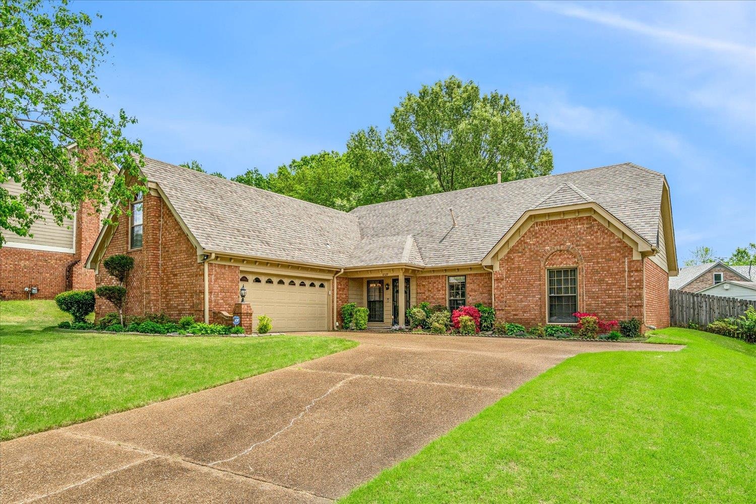 8529 Buckhurst Road Memphis, TN 38016 - Photo 2 of 36 Ranch-style home with brick siding, a shingled roof, driveway, and a garage